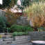 A sunken outdoor area with a curving masonry wall.