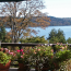 A deck with flower planters, deck furniture, and a sweeping view of puget sound.